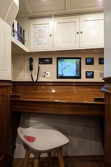 a desk with a computer and a television on it aboard VIJONARA Yacht for Sale