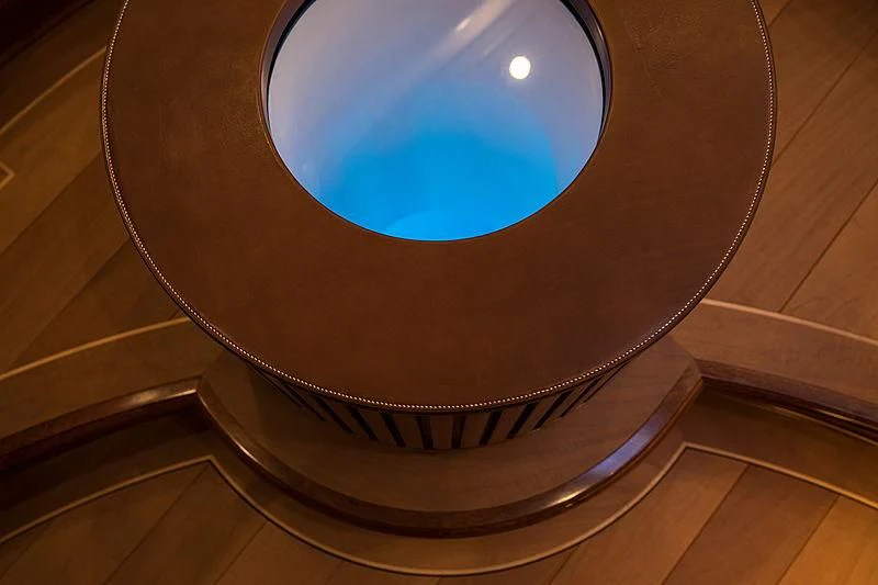 a blue ball on a wooden surface aboard VIJONARA Yacht for Sale