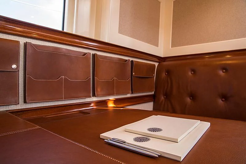 a white book on a table aboard VIJONARA Yacht for Sale