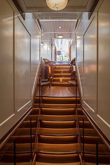 a long wooden staircase aboard VIJONARA Yacht for Sale