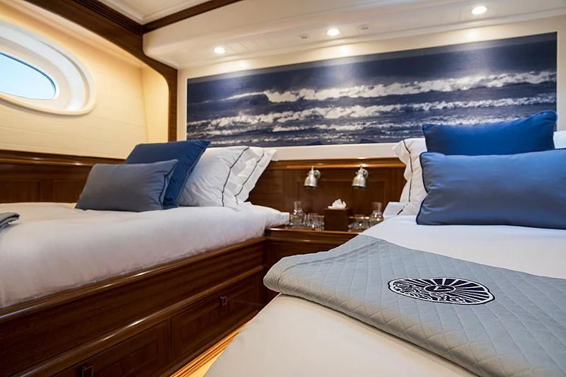 a room with beds and a mirror aboard VIJONARA Yacht for Sale