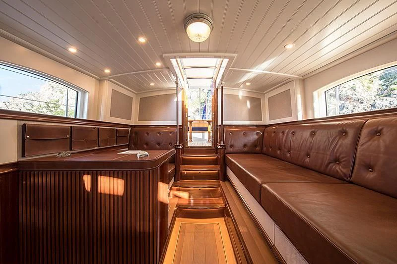 a room with wooden furniture aboard VIJONARA Yacht for Sale