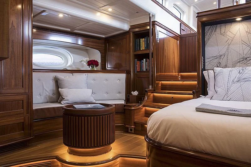 a room with a bed and a table aboard VIJONARA Yacht for Sale