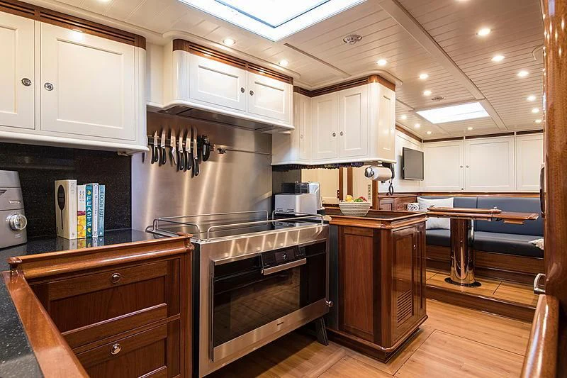 a kitchen with wooden cabinets aboard VIJONARA Yacht for Sale