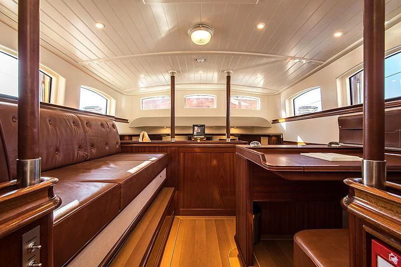 a room with wooden furniture aboard VIJONARA Yacht for Sale