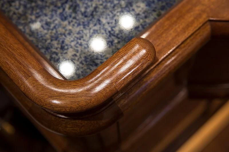a wooden chair with a white circle on the seat aboard VIJONARA Yacht for Sale