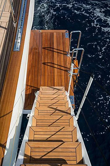 a wooden staircase with a railing aboard VIJONARA Yacht for Sale