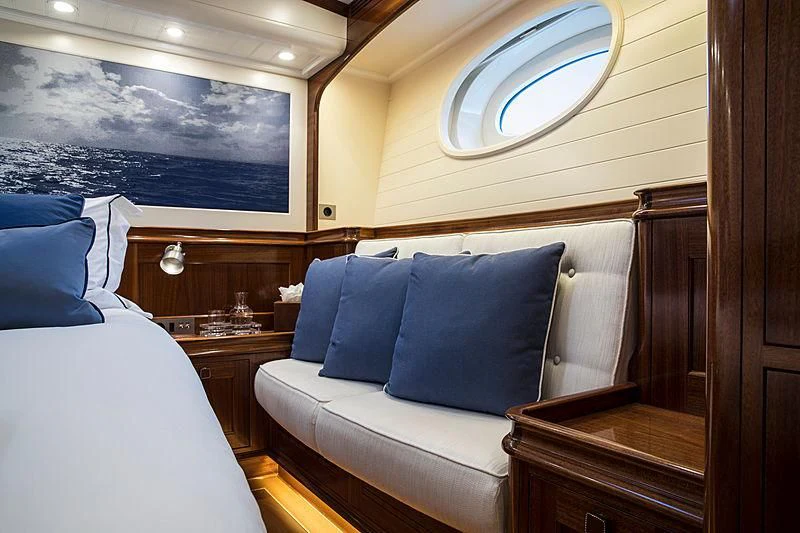 a room with a bed and a window aboard VIJONARA Yacht for Sale