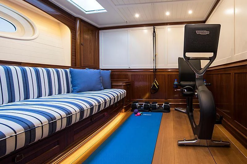 a gym with a couch and a bed aboard VIJONARA Yacht for Sale