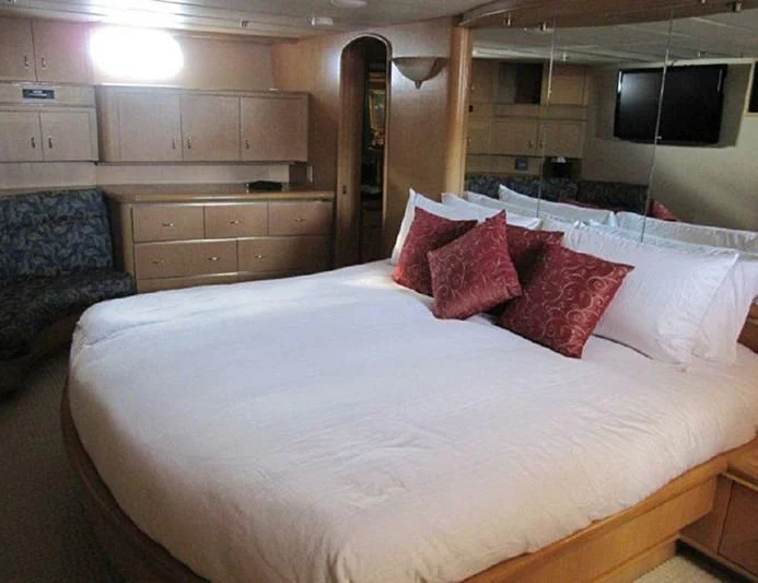 a bed with pillows aboard LARA'S THEME Yacht for Sale