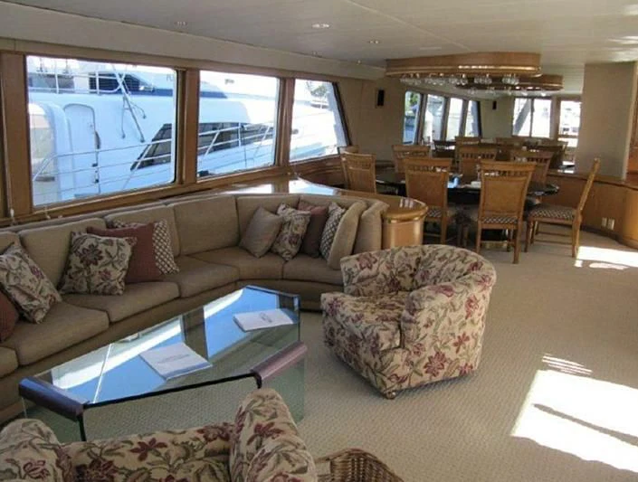a living room with a couch and a table aboard LARA'S THEME Yacht for Sale