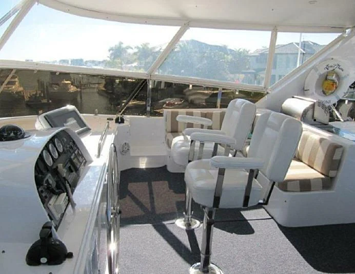 a room with a table chairs and a large window aboard LARA'S THEME Yacht for Sale