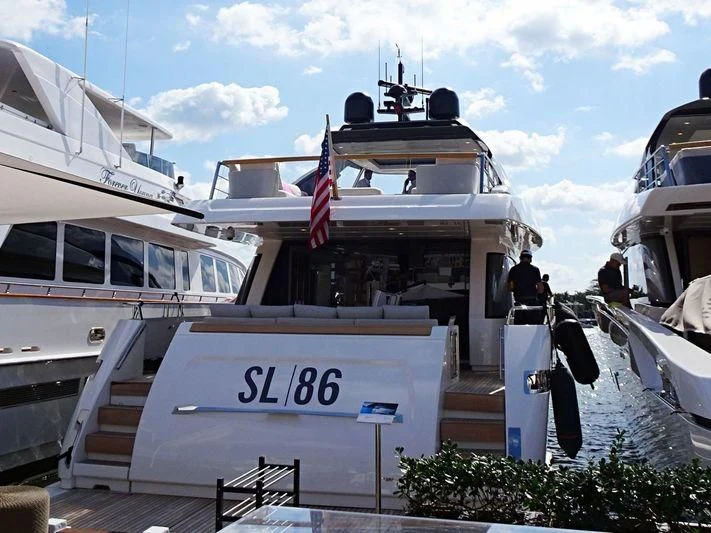 a boat docked with a flag aboard EASIEST CHILD Yacht for Sale