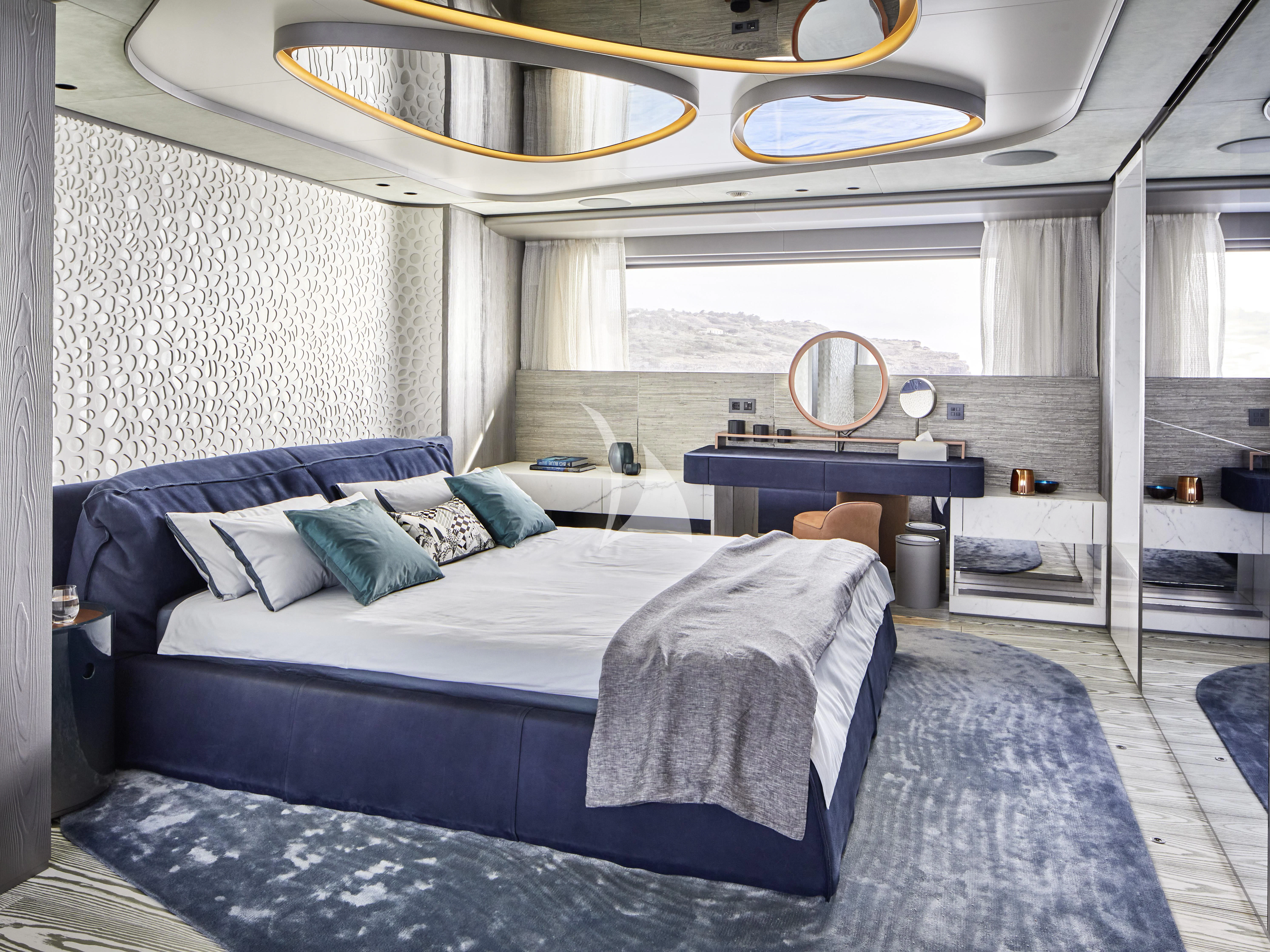 a bedroom with a bed and a mirror aboard PANDION PEARL Yacht for Charter