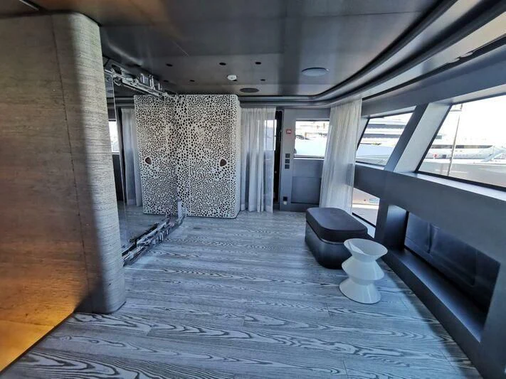 a room with a bench and a chair aboard PANDION PEARL Yacht for Charter