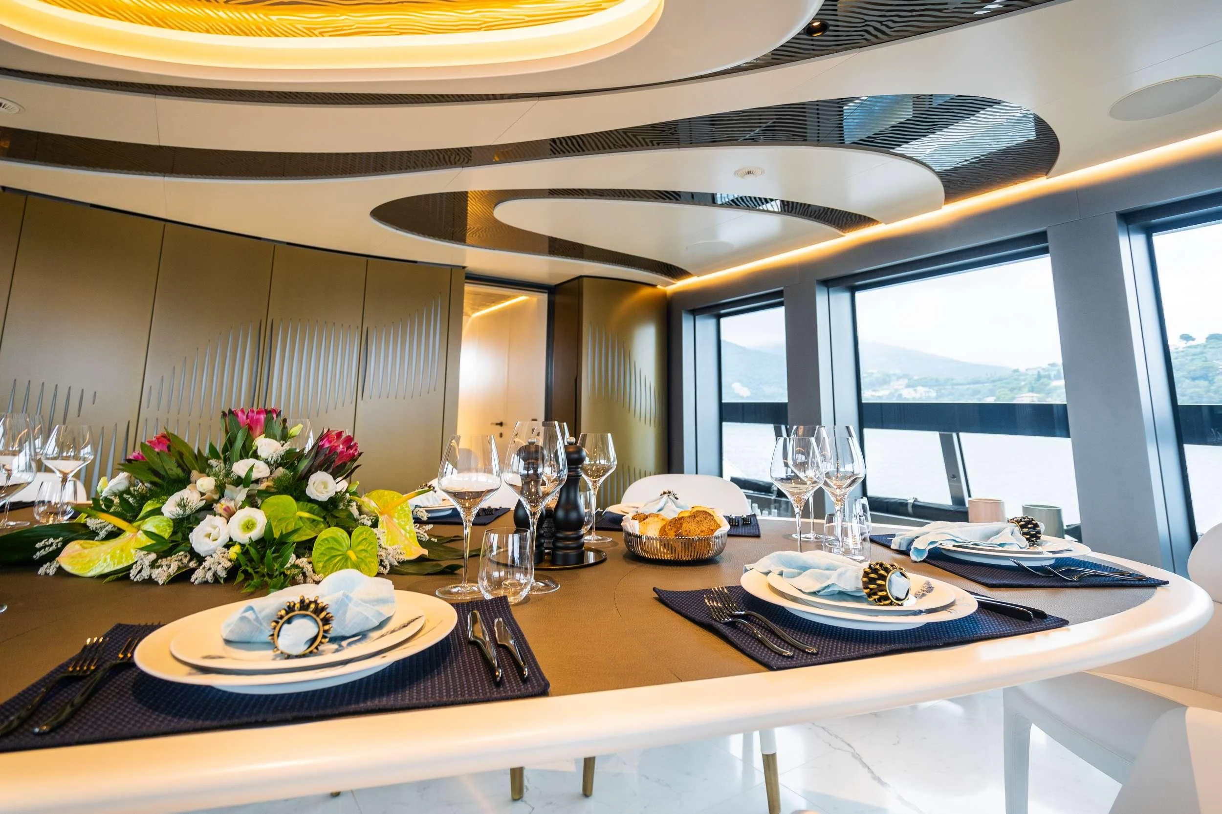 a table with plates and glasses aboard PANDION PEARL Yacht for Charter