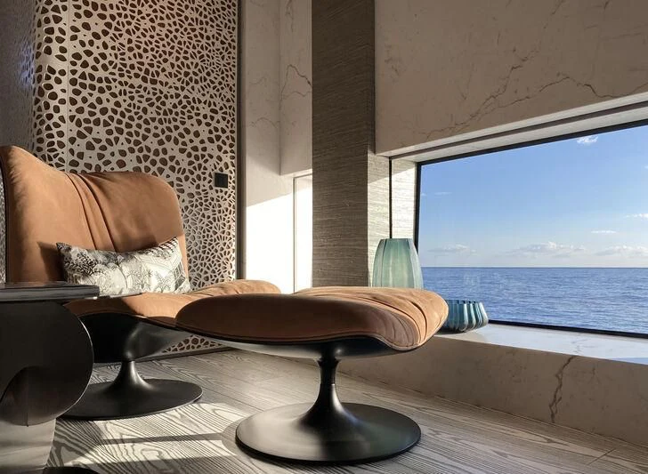 a table with a plate and a glass of liquid on it aboard PANDION PEARL Yacht for Charter