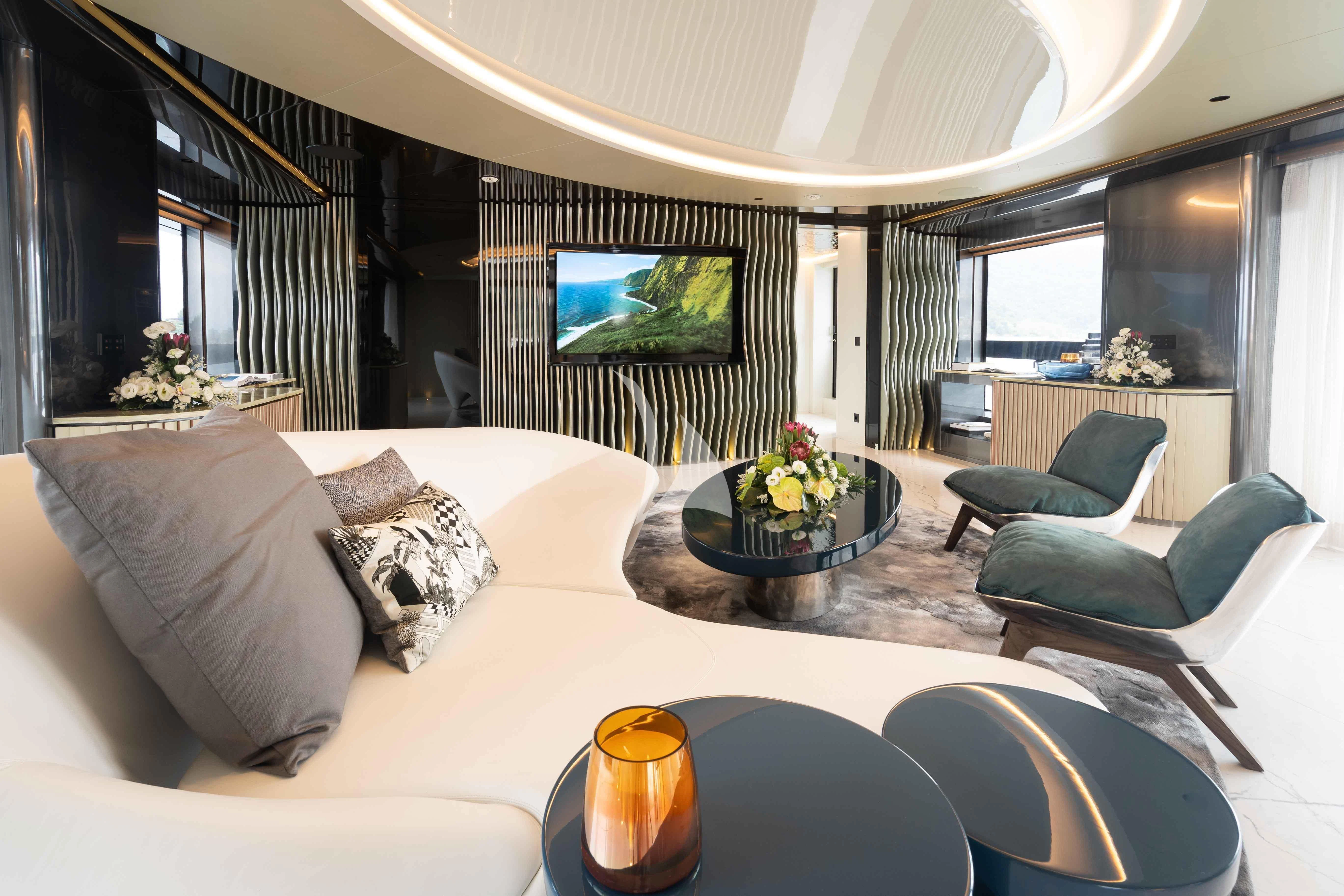 a large hotel room with a large bed and a table aboard PANDION PEARL Yacht for Charter