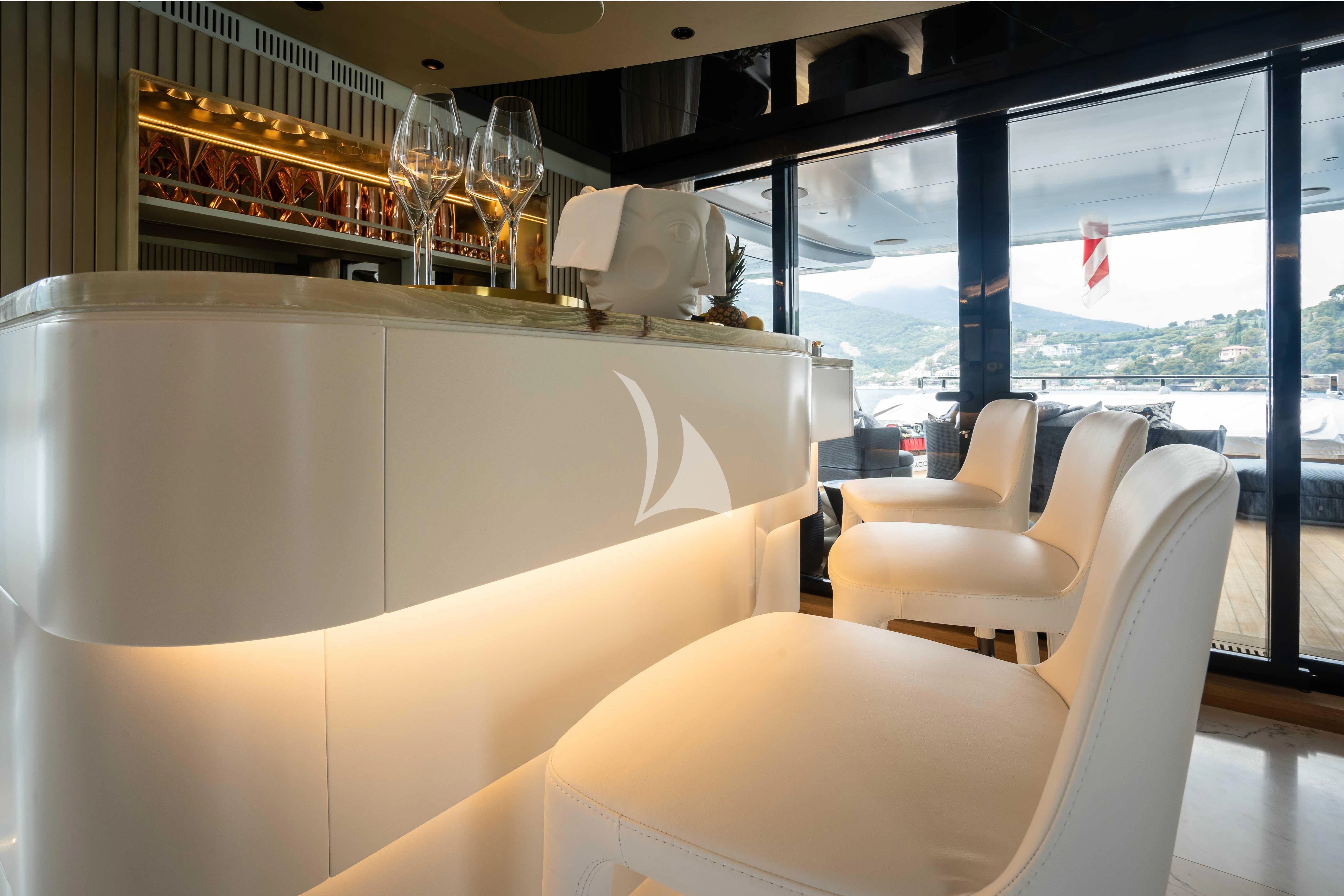 a room with chairs and a table aboard PANDION PEARL Yacht for Charter