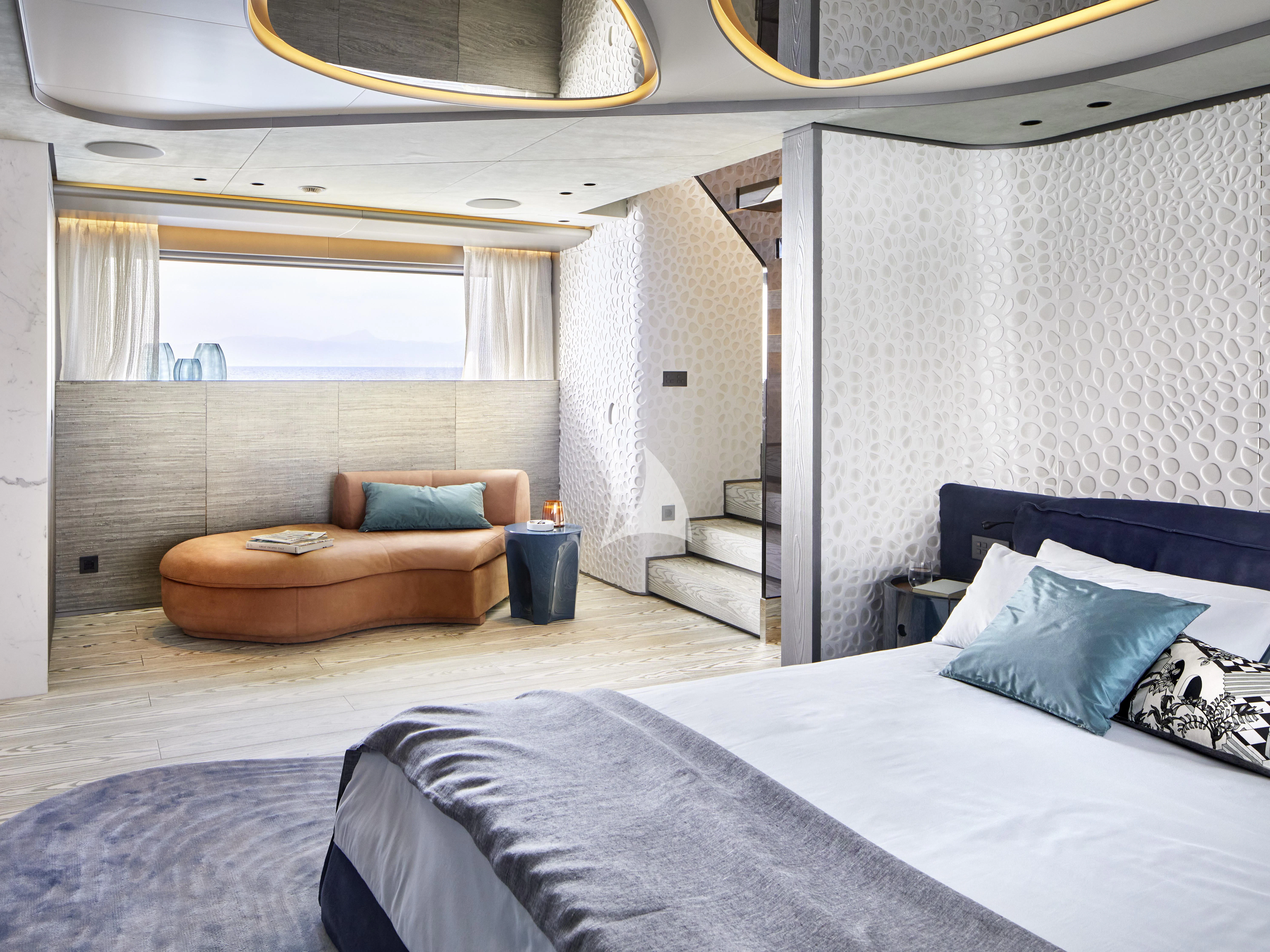 a room with a bed and a couch aboard PANDION PEARL Yacht for Charter