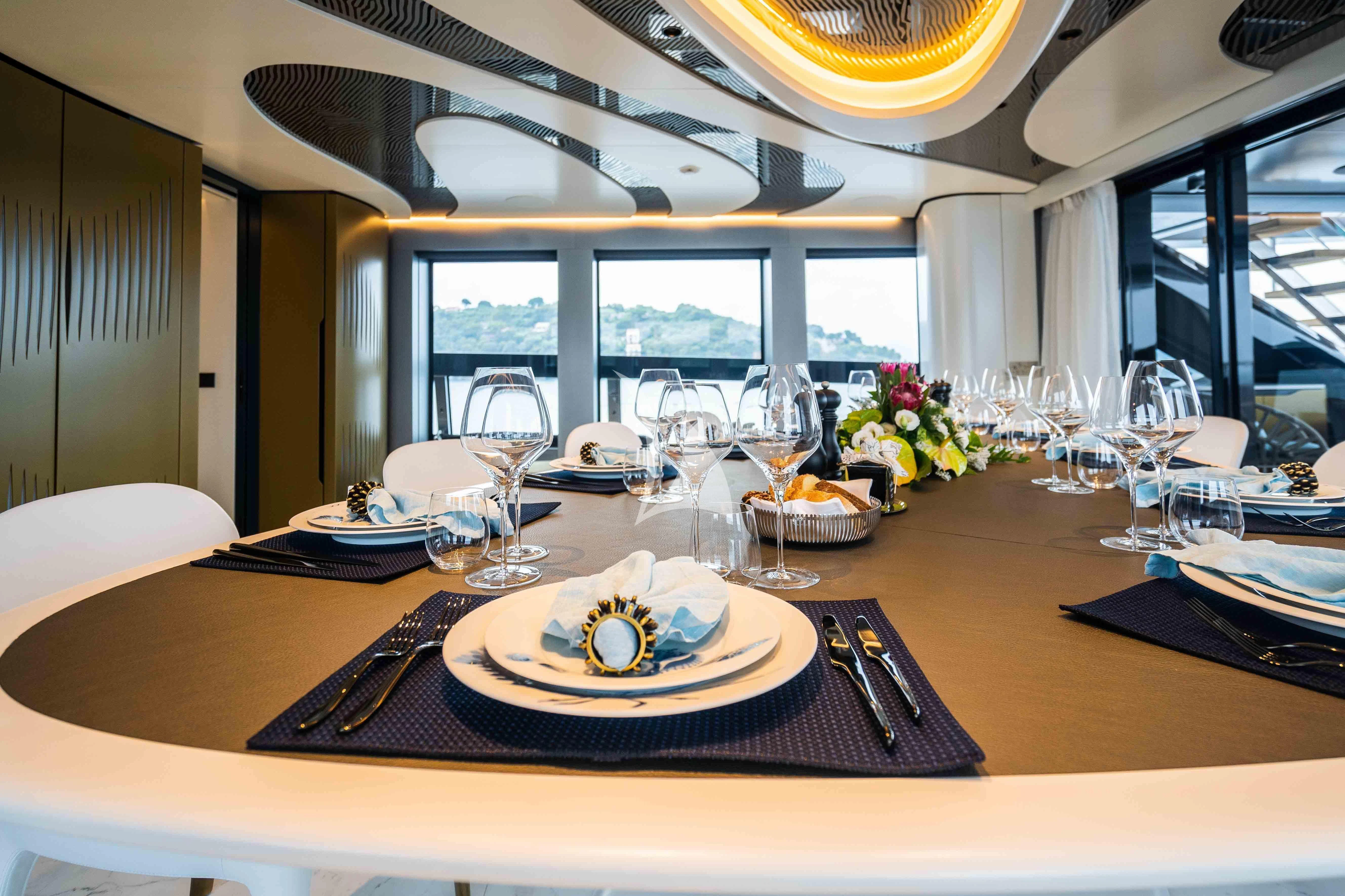 a table with plates and glasses aboard PANDION PEARL Yacht for Charter