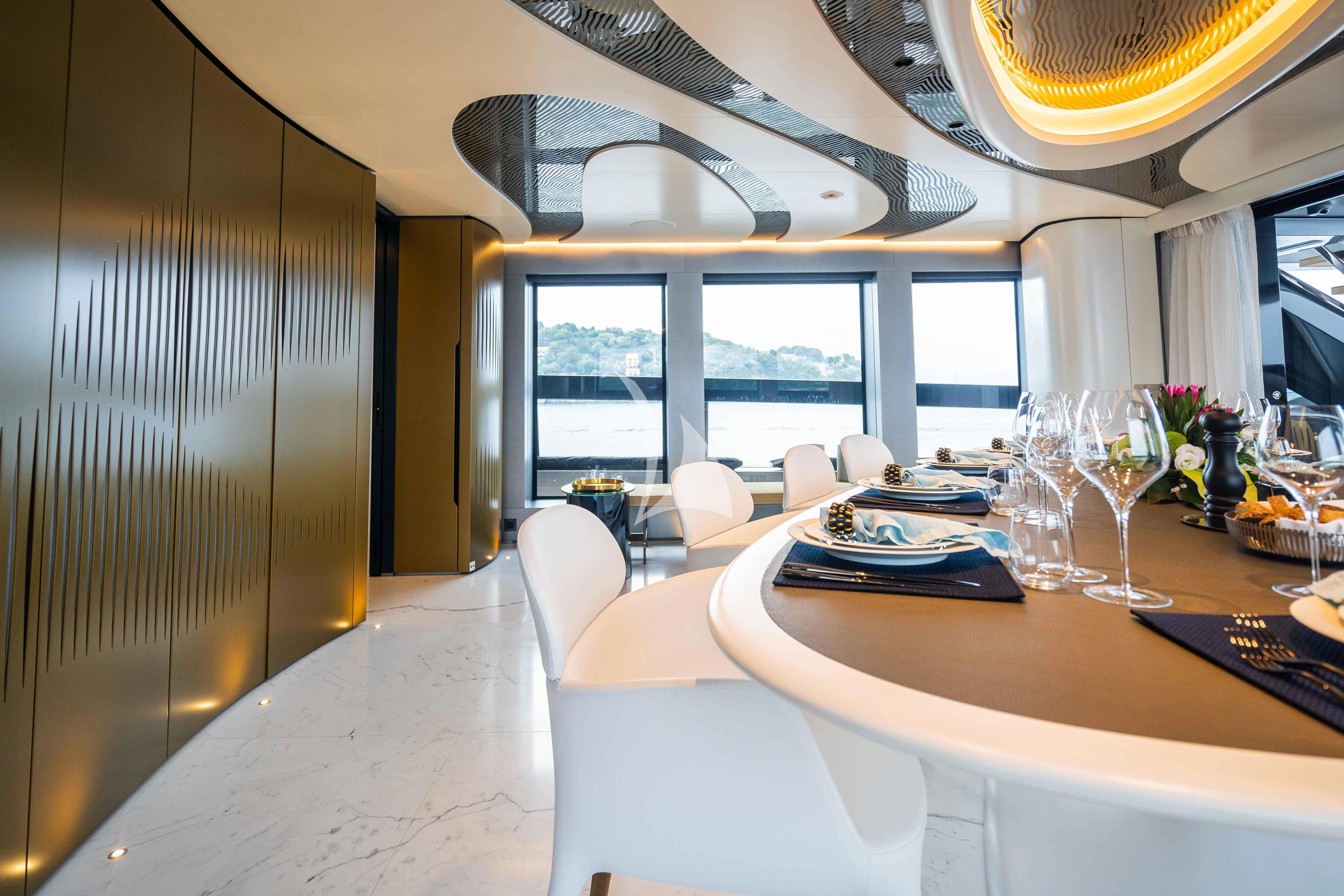 a room with a table chairs and a window aboard PANDION PEARL Yacht for Charter