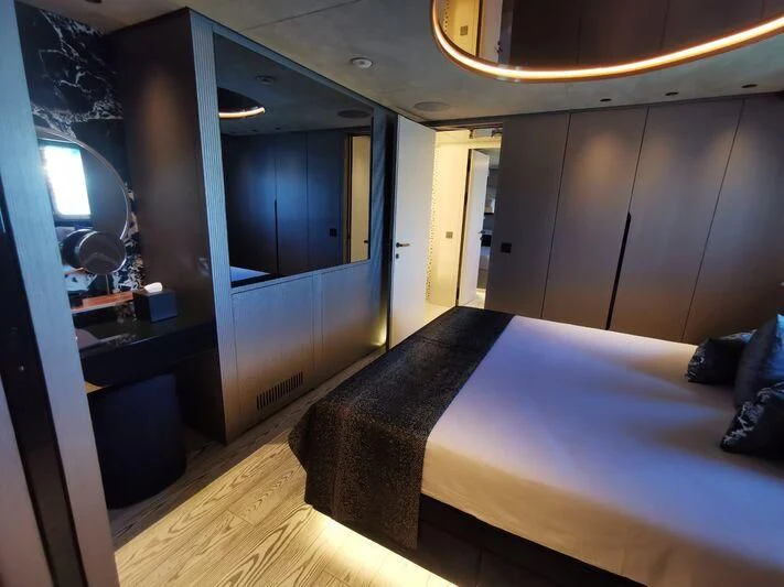 a room with a bed and a mirror aboard PANDION PEARL Yacht for Charter