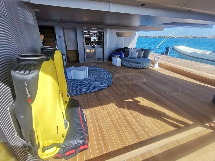 a deck with a yellow and black tarp and a large pool aboard PANDION PEARL Yacht for Charter
