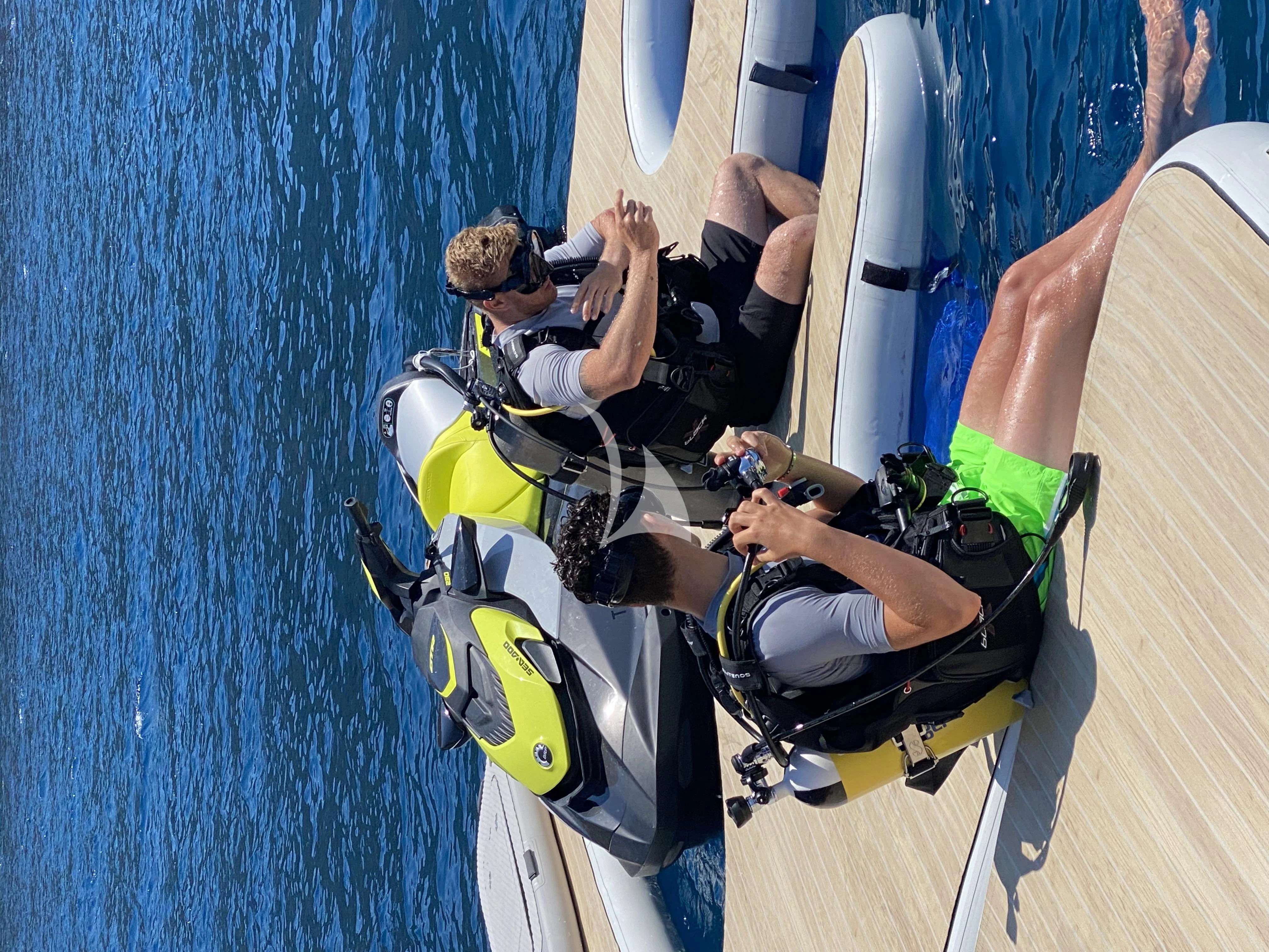 a group of people sitting in chairs aboard PANDION PEARL Yacht for Charter
