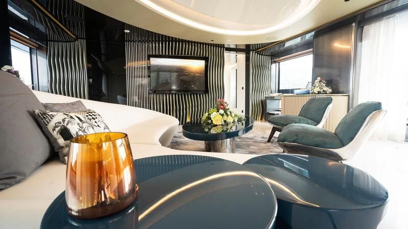 a room with a table chairs and a glass of beer aboard PANDION PEARL Yacht for Charter