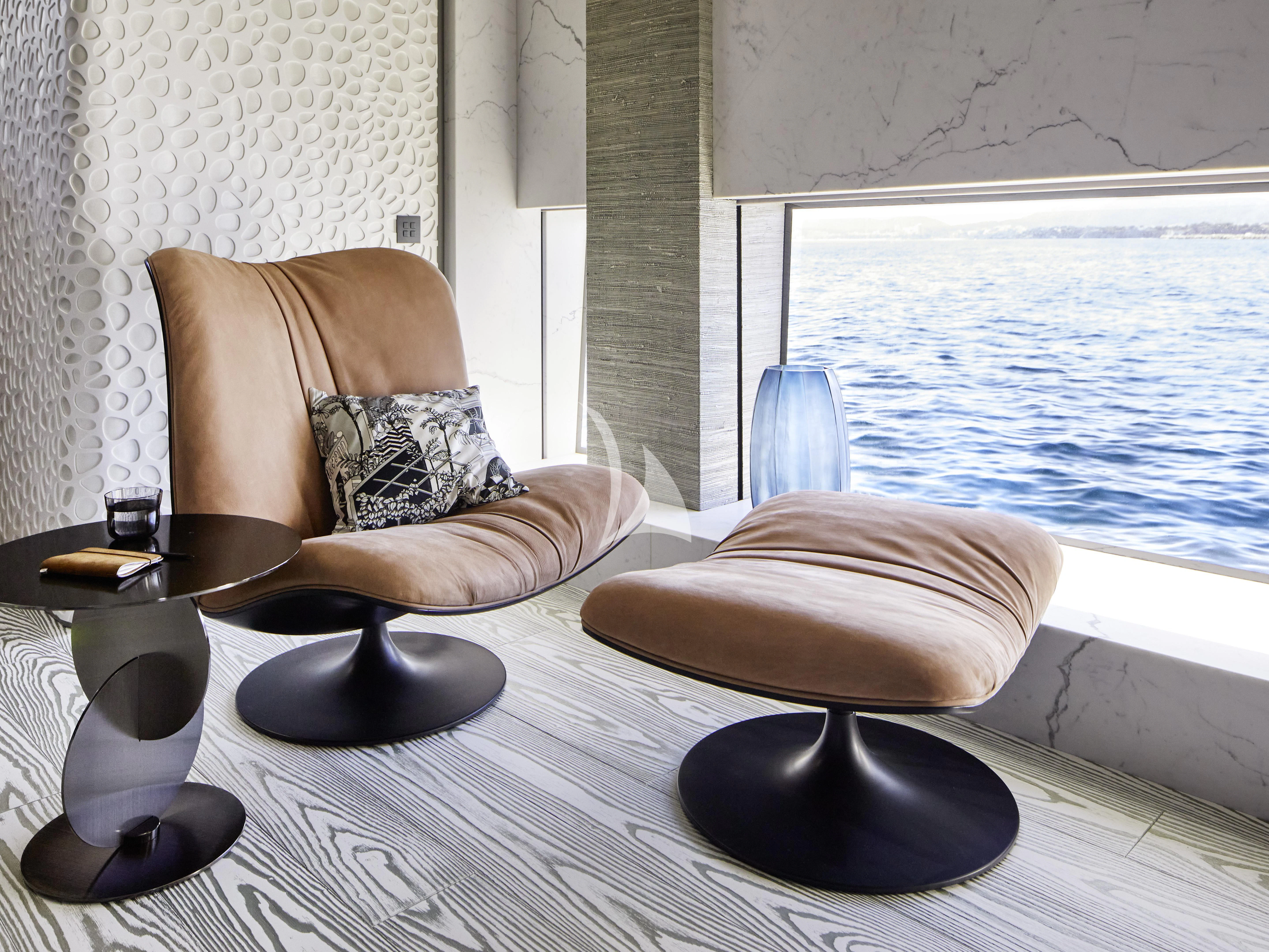 a person sitting on a chair by a window aboard PANDION PEARL Yacht for Charter