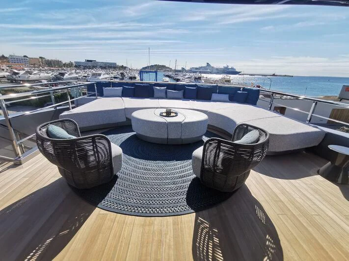 a large white and black swimming pool on a deck overlooking a city aboard PANDION PEARL Yacht for Charter