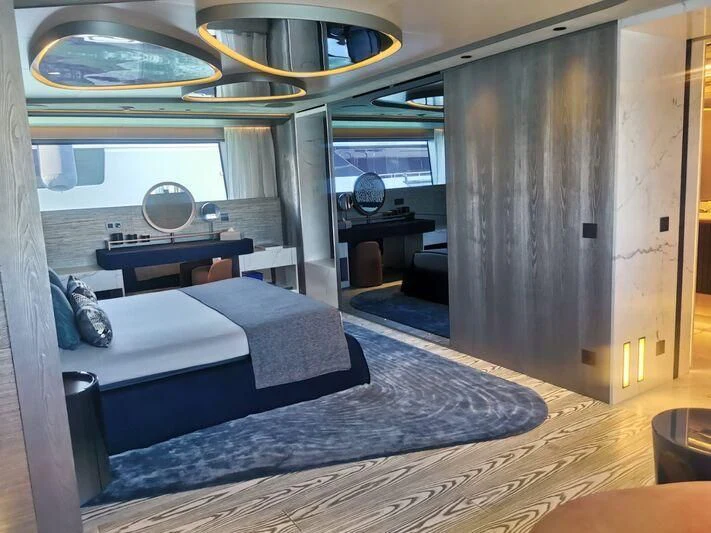 a room with a bed and a desk aboard PANDION PEARL Yacht for Charter