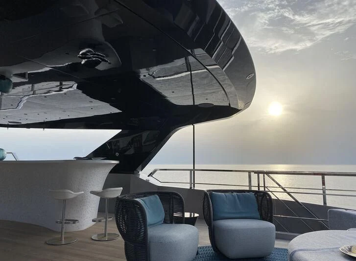 a large airplane flying over a deck aboard PANDION PEARL Yacht for Charter