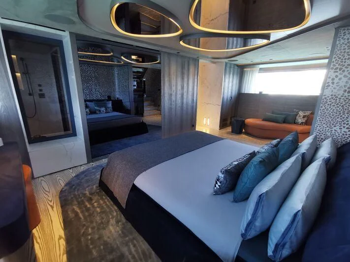 a large bedroom with a large bed aboard PANDION PEARL Yacht for Charter