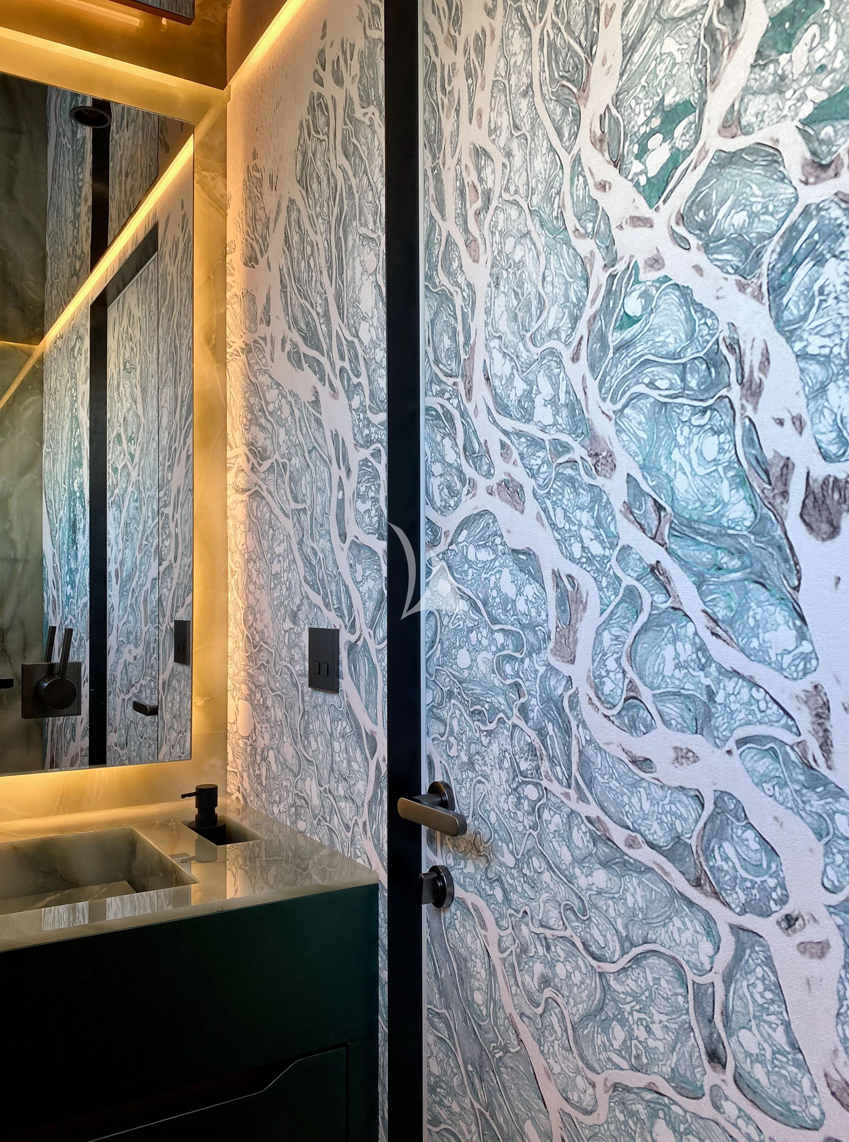 a bathroom with a sink and a shower curtain aboard PANDION PEARL Yacht for Charter