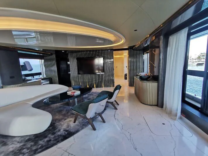 a room with a large window and a table and chairs aboard PANDION PEARL Yacht for Charter