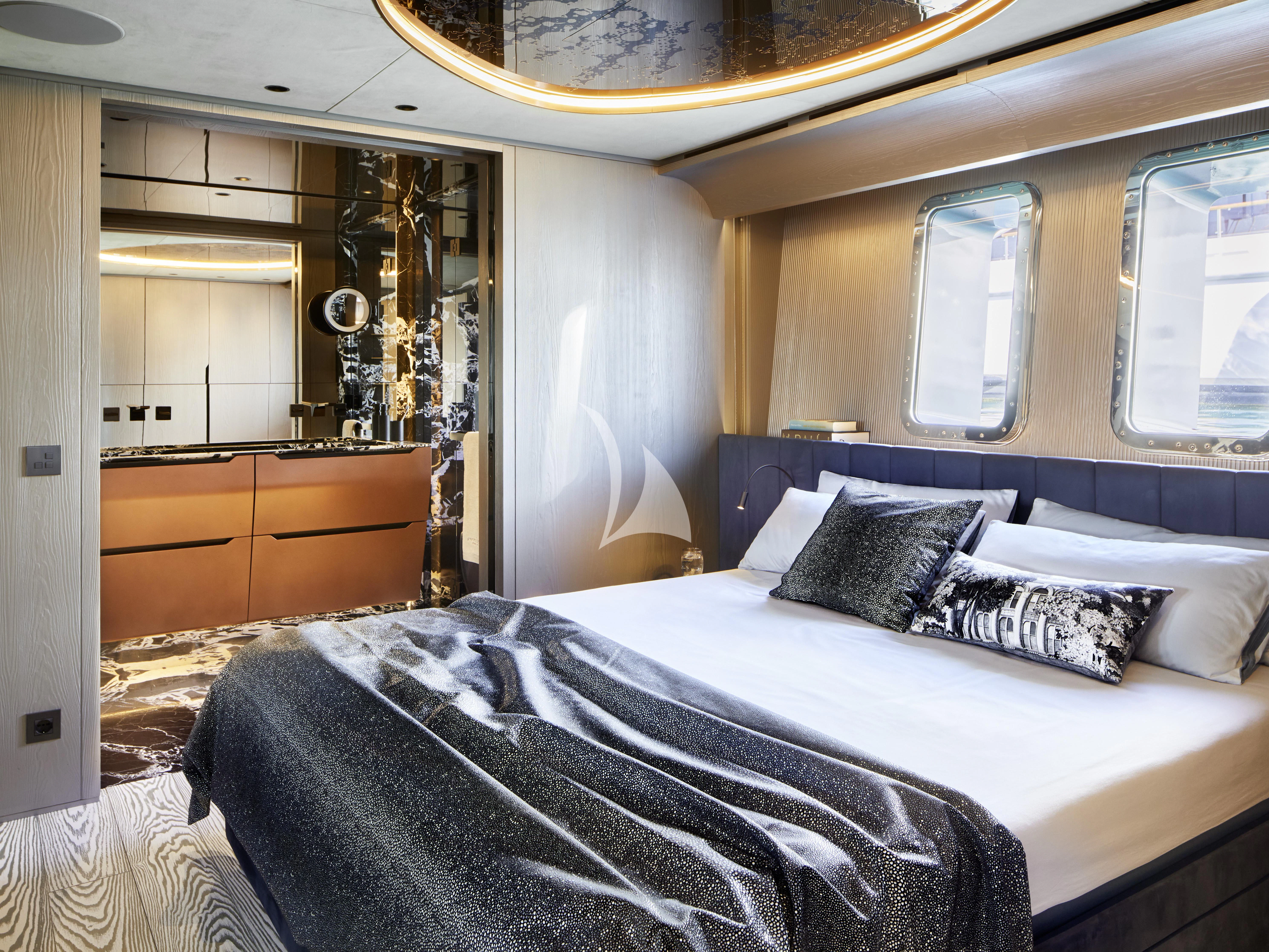 a bedroom with a bed and a dresser aboard PANDION PEARL Yacht for Charter