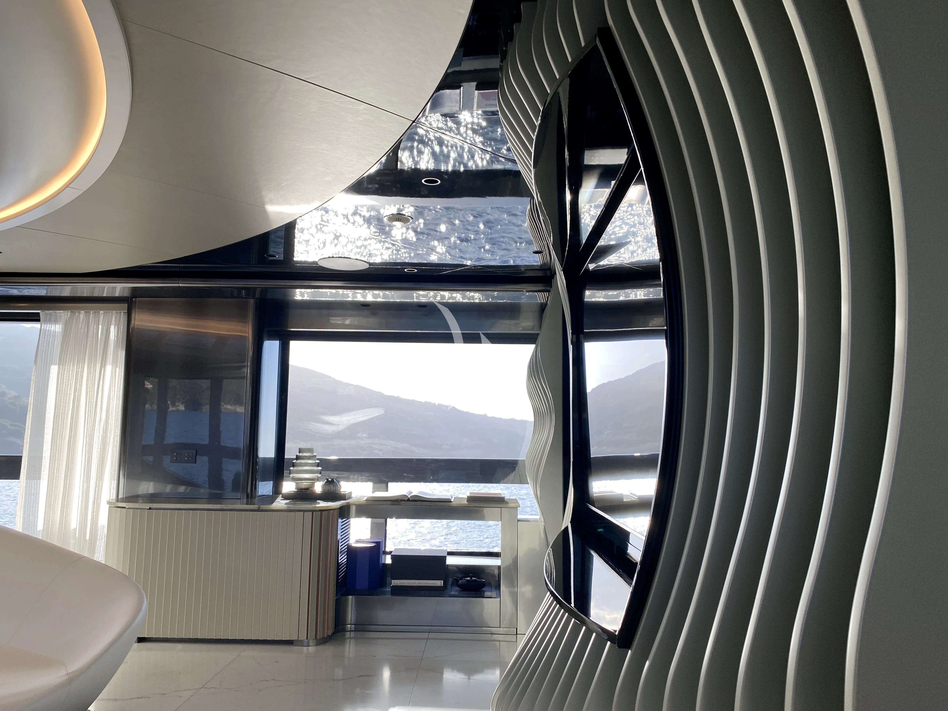 a room with a large window aboard PANDION PEARL Yacht for Charter