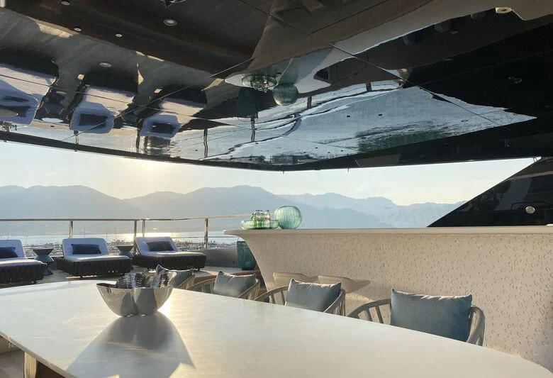 a room with a table and chairs aboard PANDION PEARL Yacht for Charter