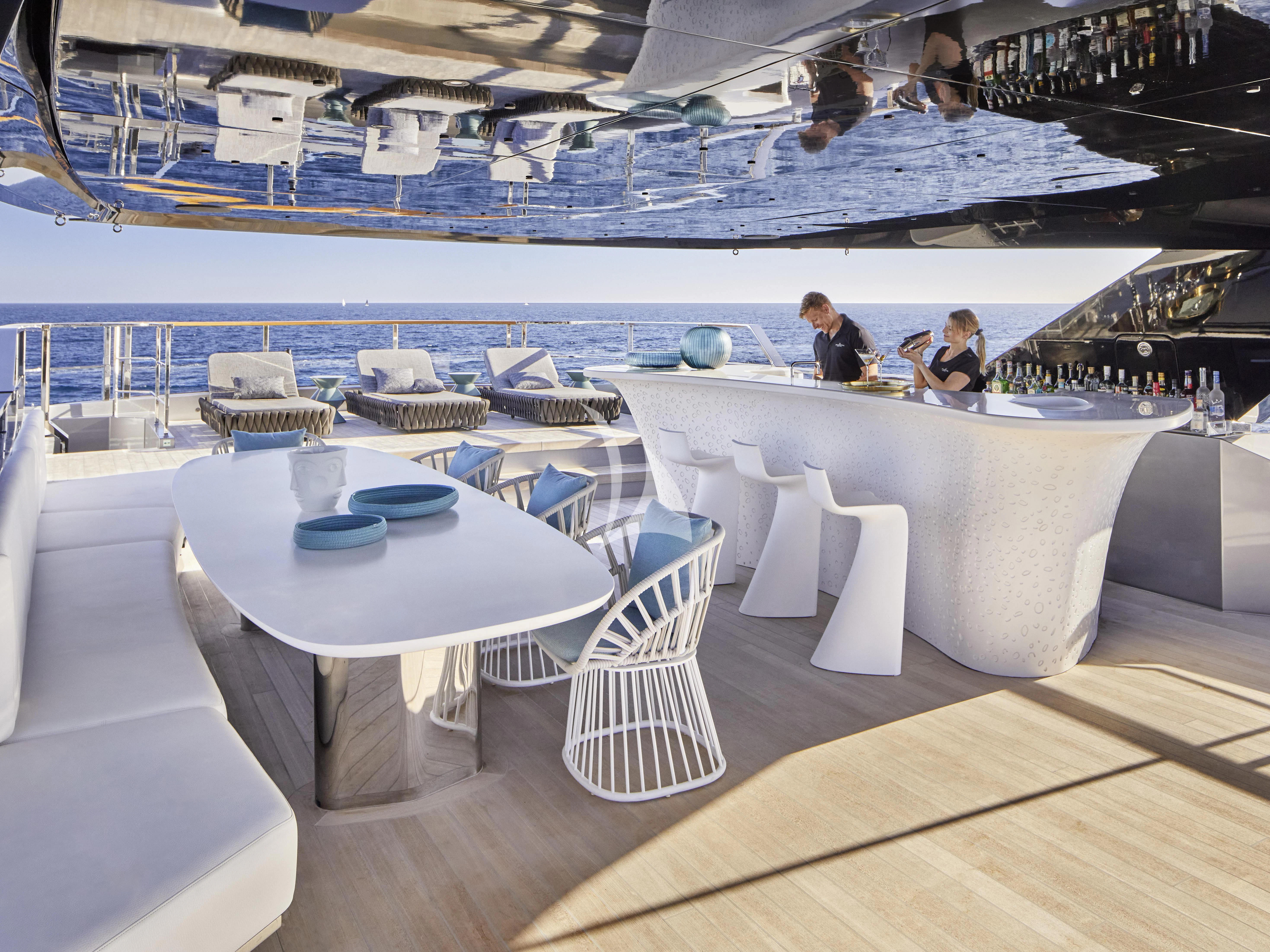 a room with a table and chairs aboard PANDION PEARL Yacht for Charter