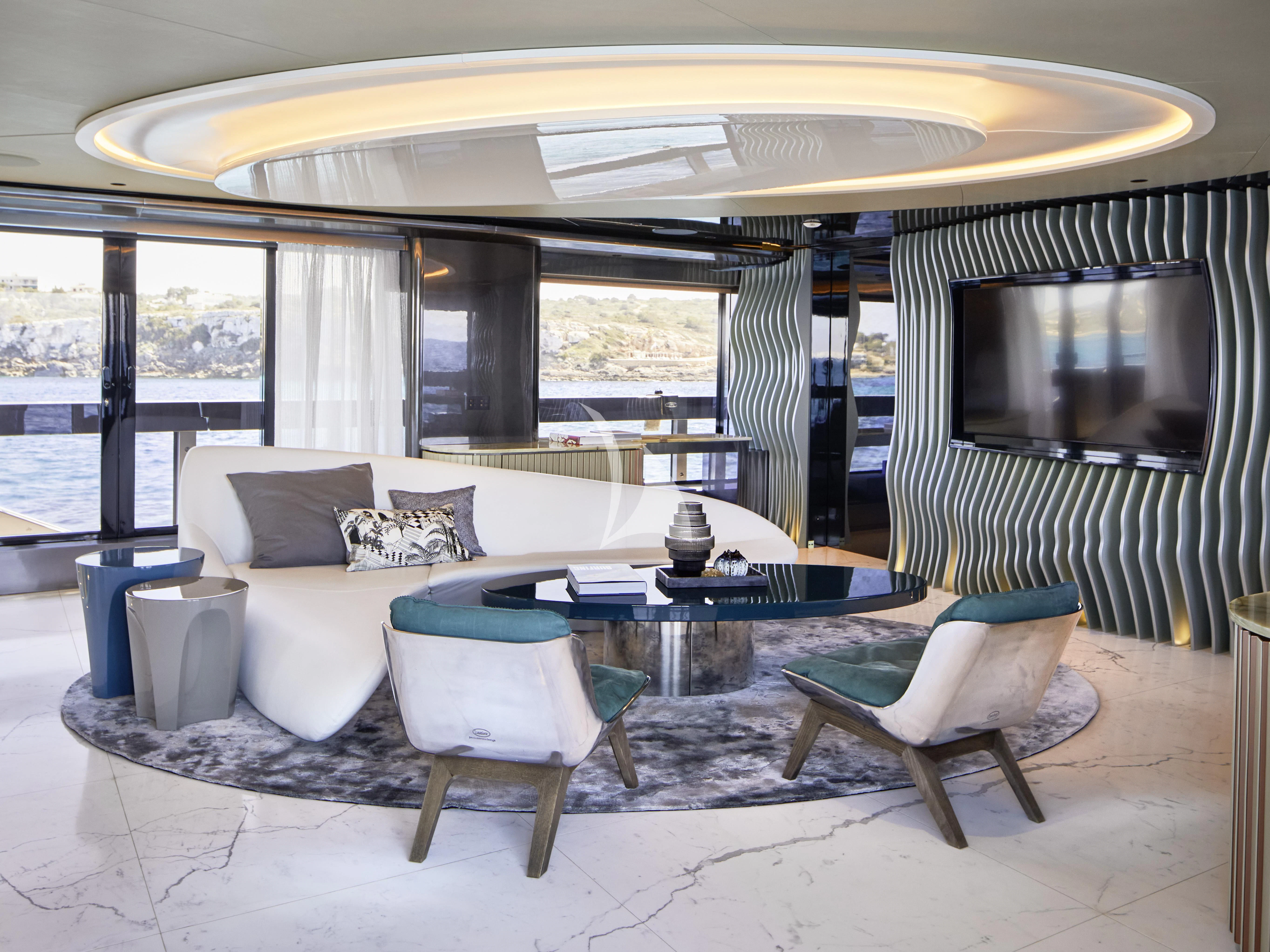a living room with a large table and chairs aboard PANDION PEARL Yacht for Charter