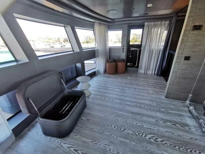 a room with a tv and a couch aboard PANDION PEARL Yacht for Charter
