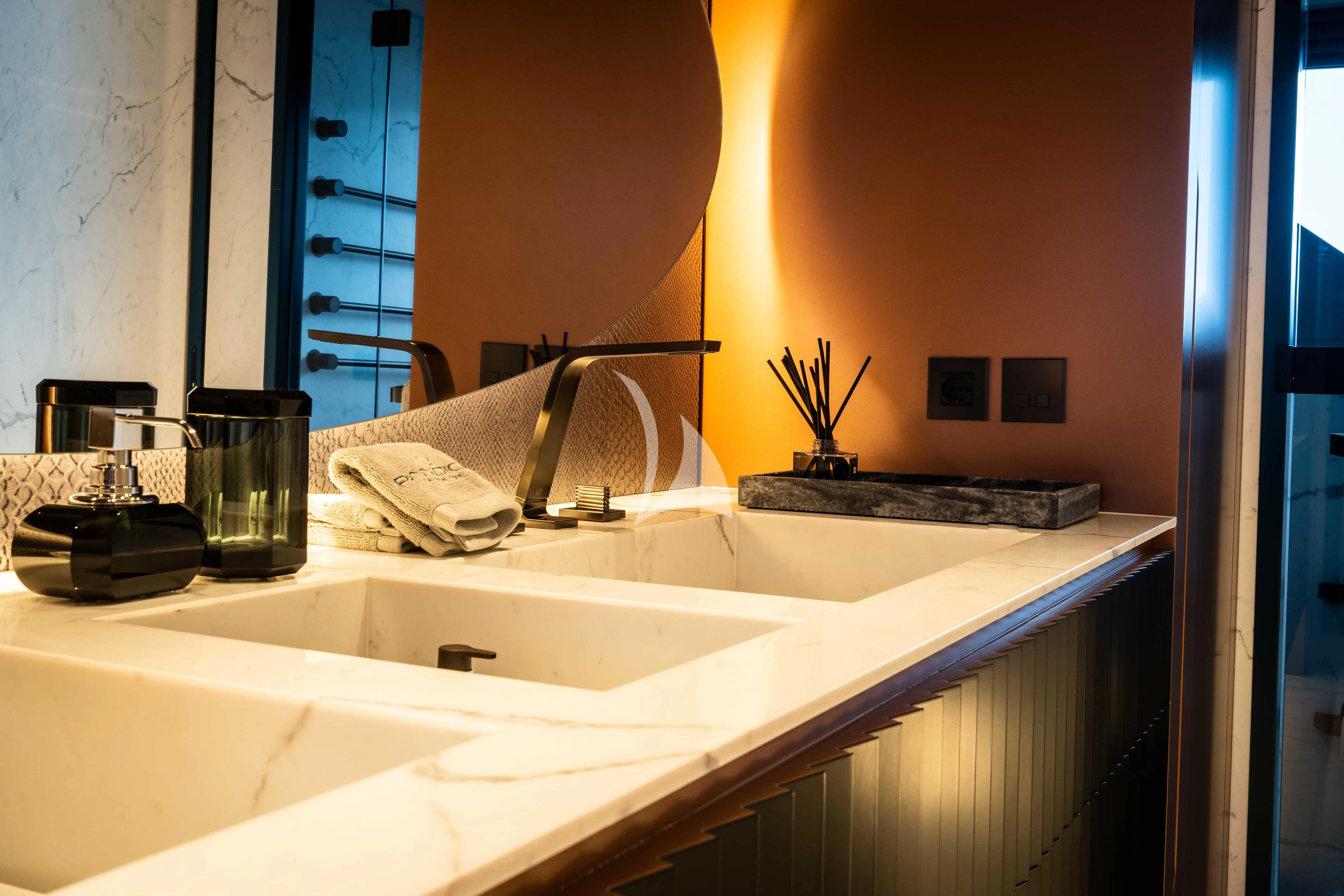 a bathroom with a sink and a mirror aboard PANDION PEARL Yacht for Charter