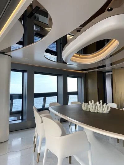 a room with a table and chairs aboard PANDION PEARL Yacht for Charter