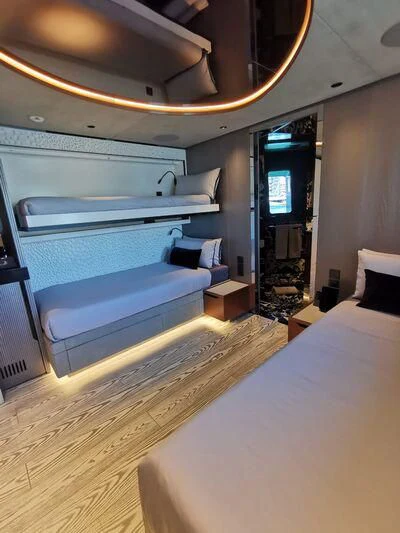 a room with a bed and a couch aboard PANDION PEARL Yacht for Charter