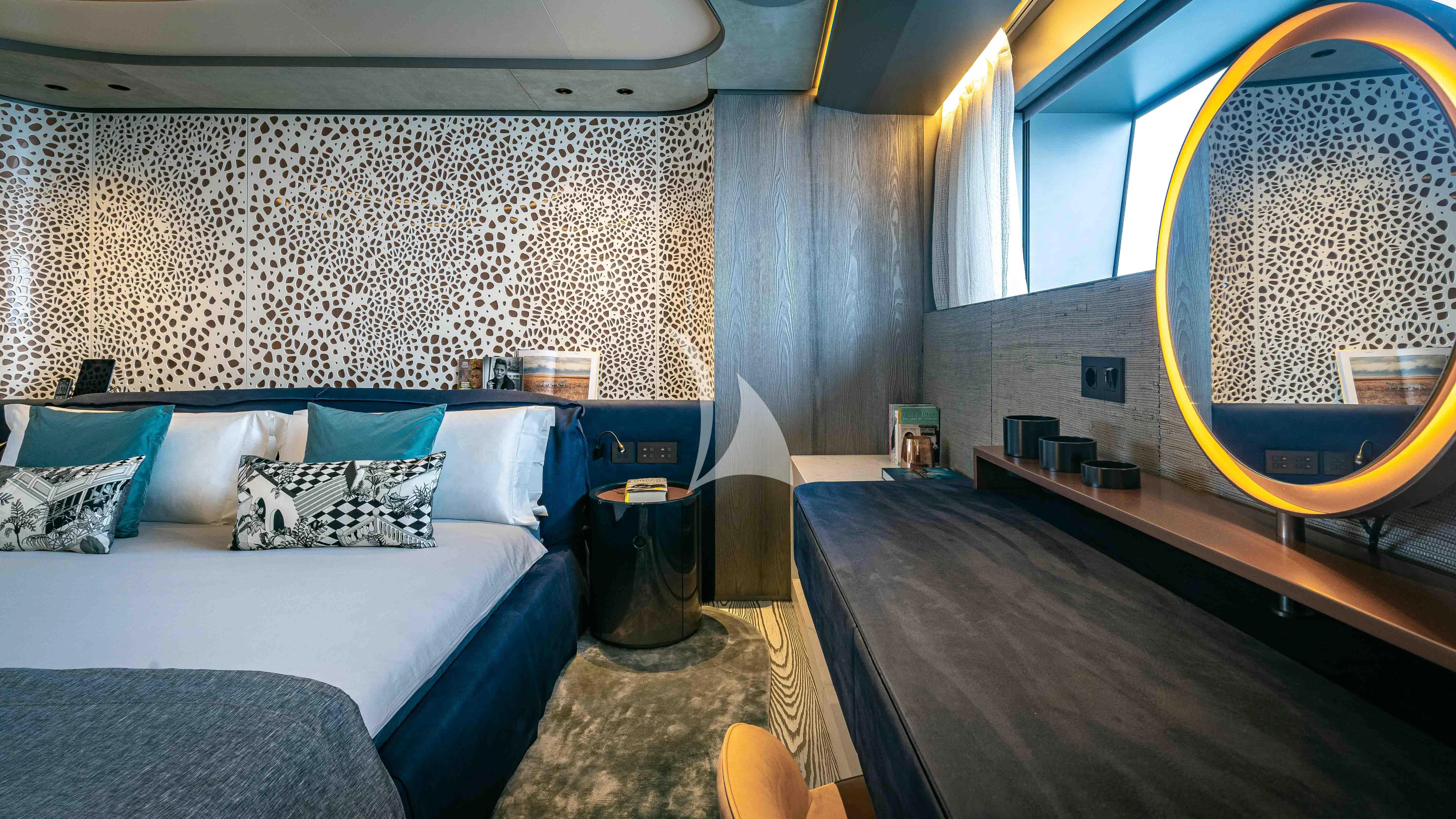 a room with a bed and a mirror aboard PANDION PEARL Yacht for Charter