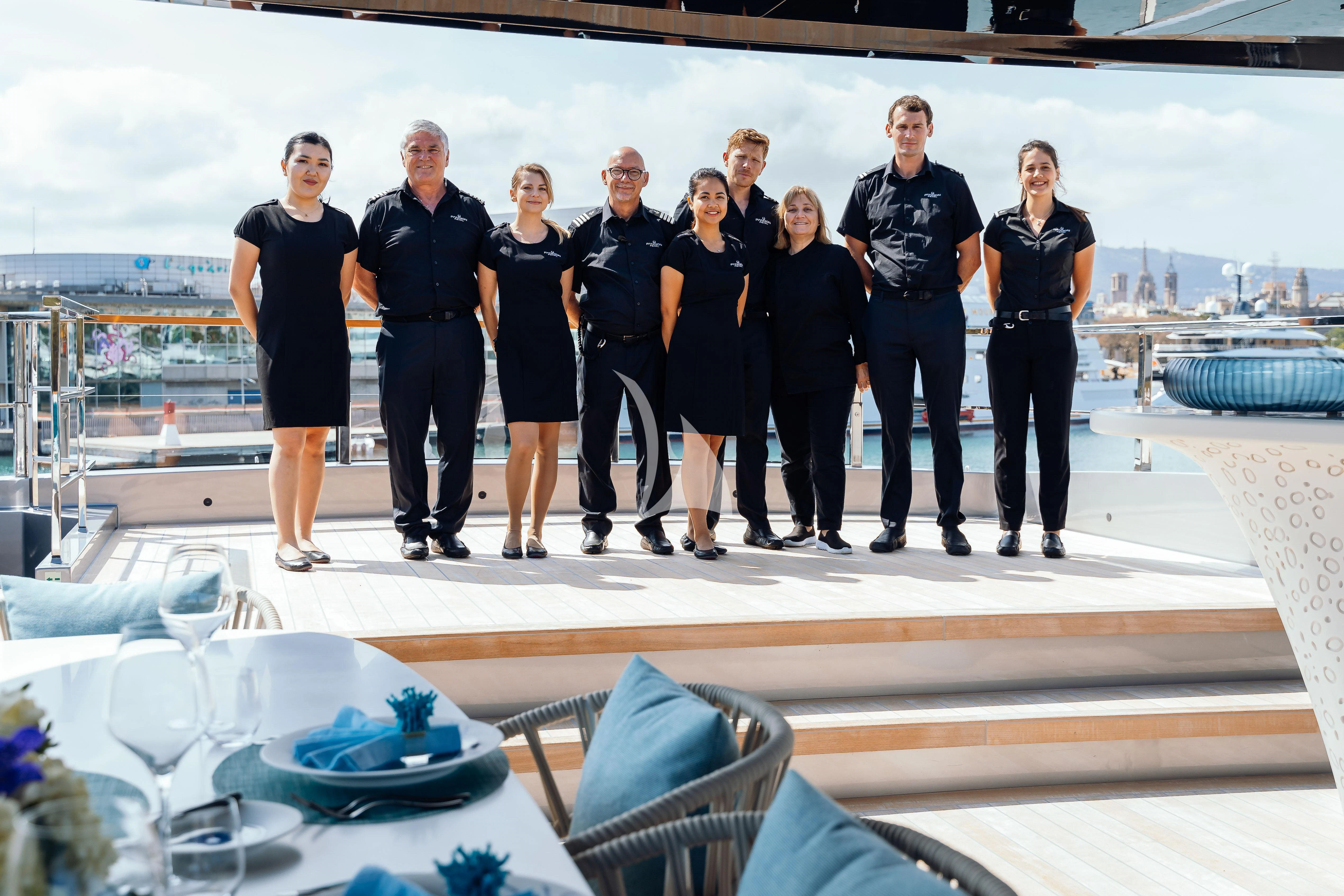 a group of people posing for a photo on a boat aboard PANDION PEARL Yacht for Charter