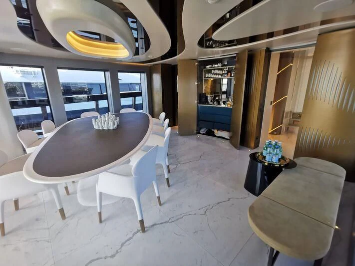 a room with a table and chairs aboard PANDION PEARL Yacht for Charter
