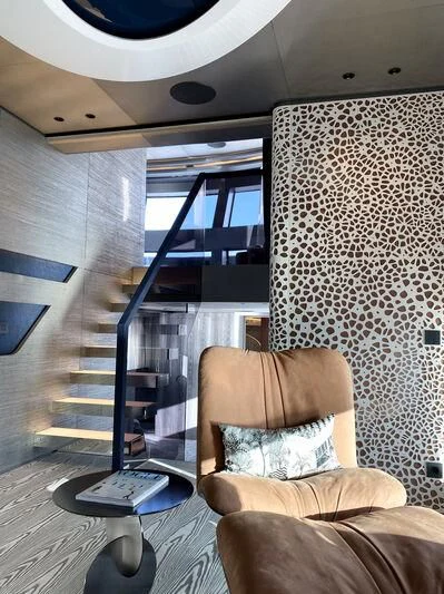 a room with a chair and a table aboard PANDION PEARL Yacht for Charter